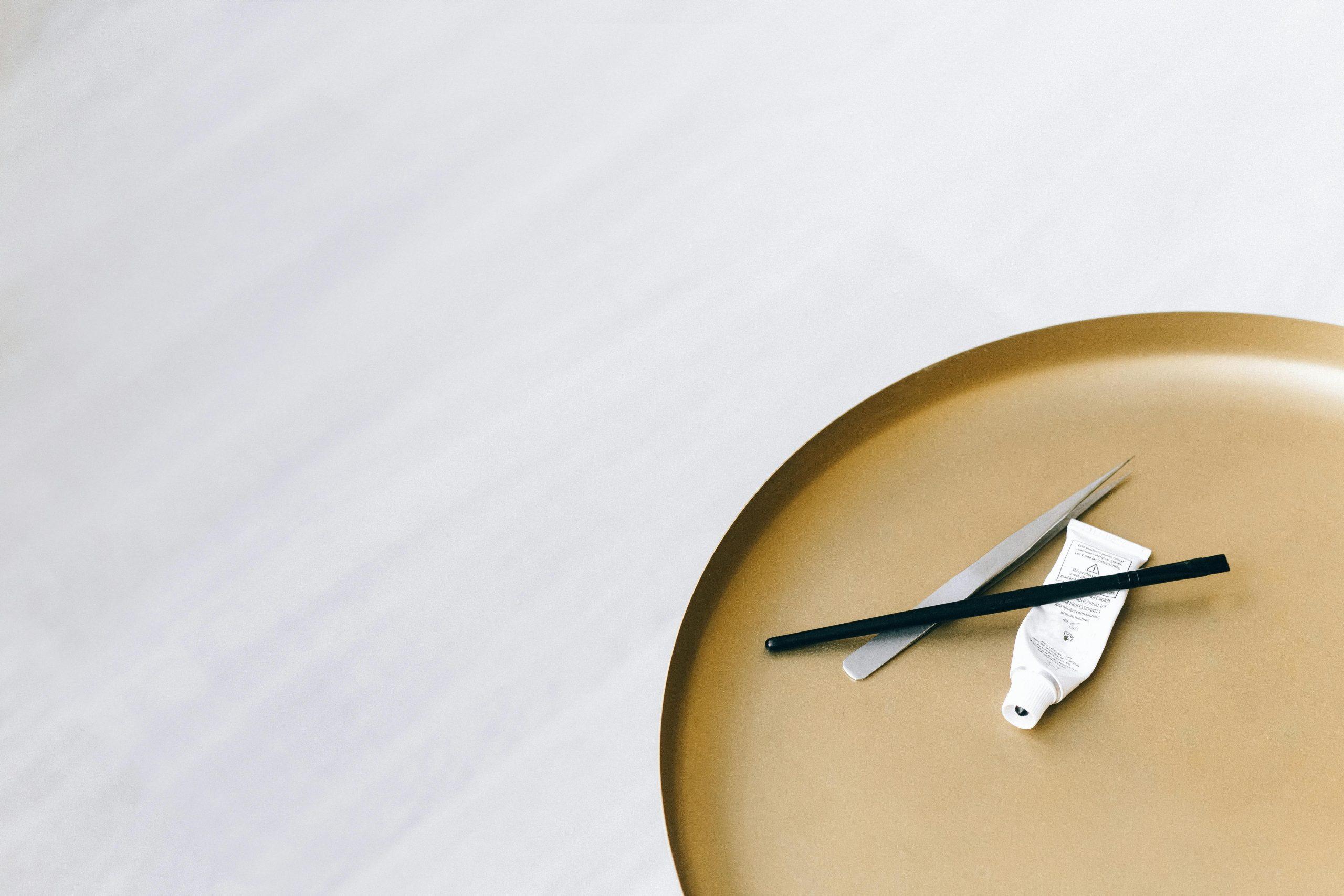 A close-up shot of a makeup artist working on intricate eye makeup design