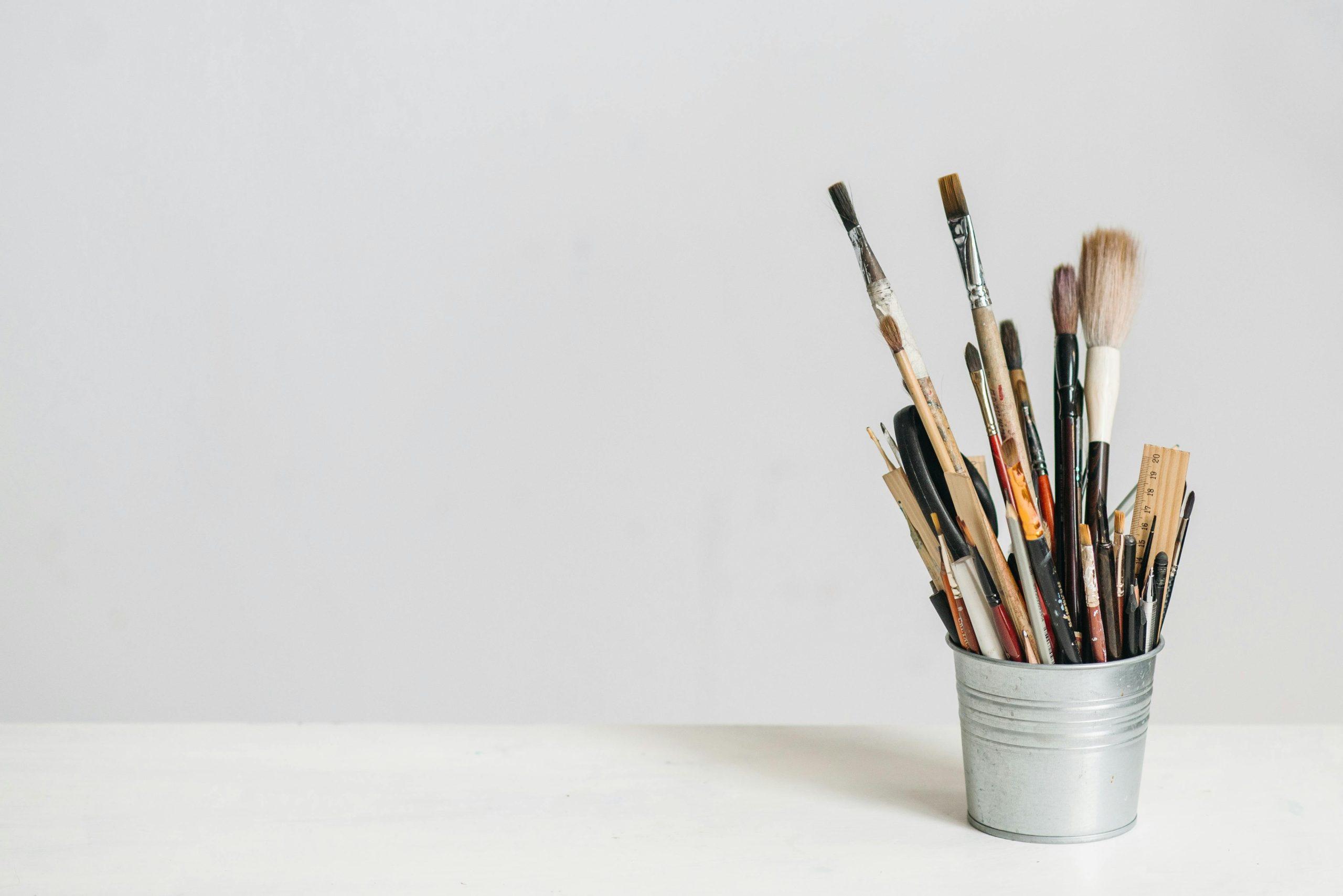 A makeup artist organizing brushes at a workspace