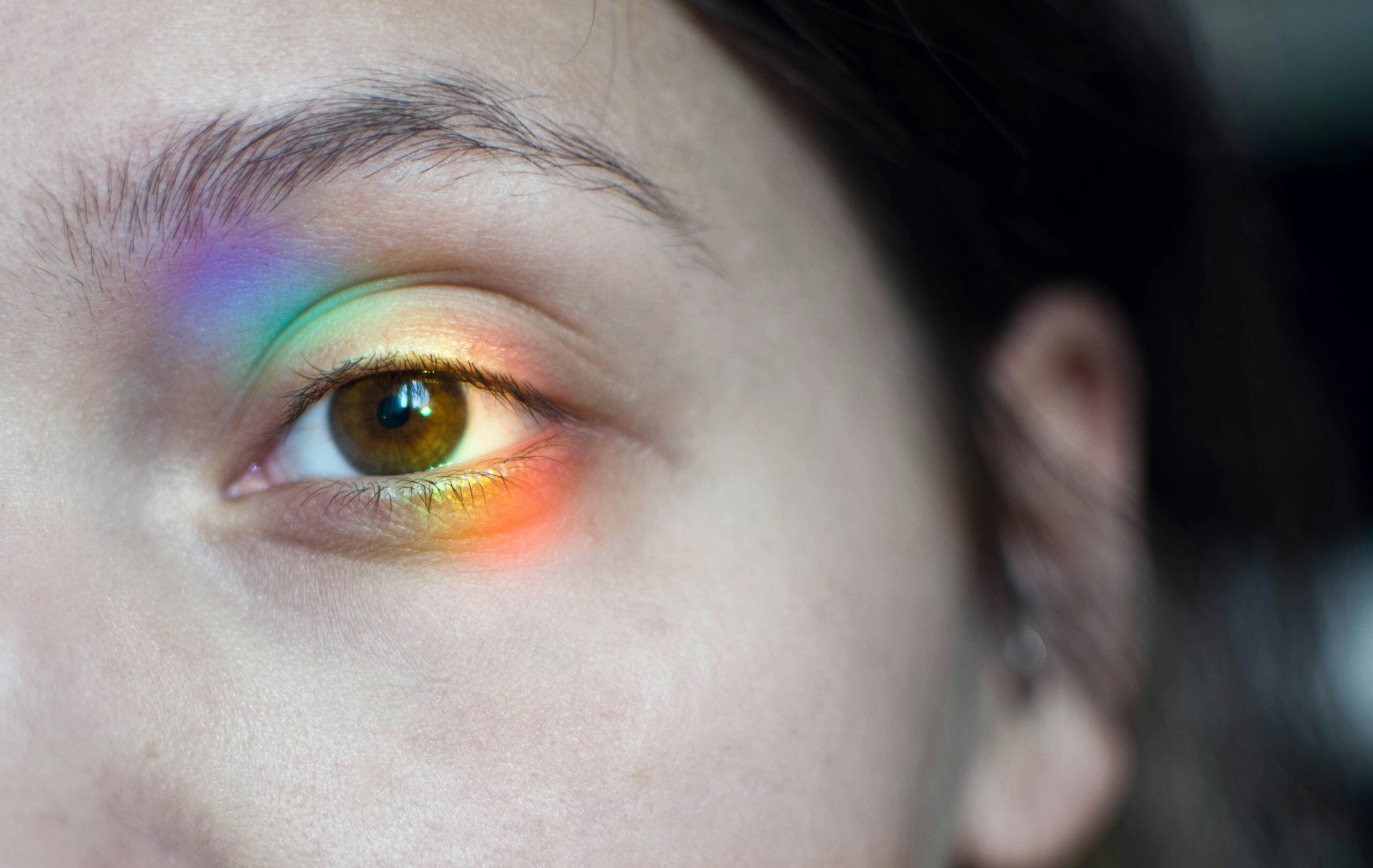An artist showcasing perfectly blended rainbow eye shadows