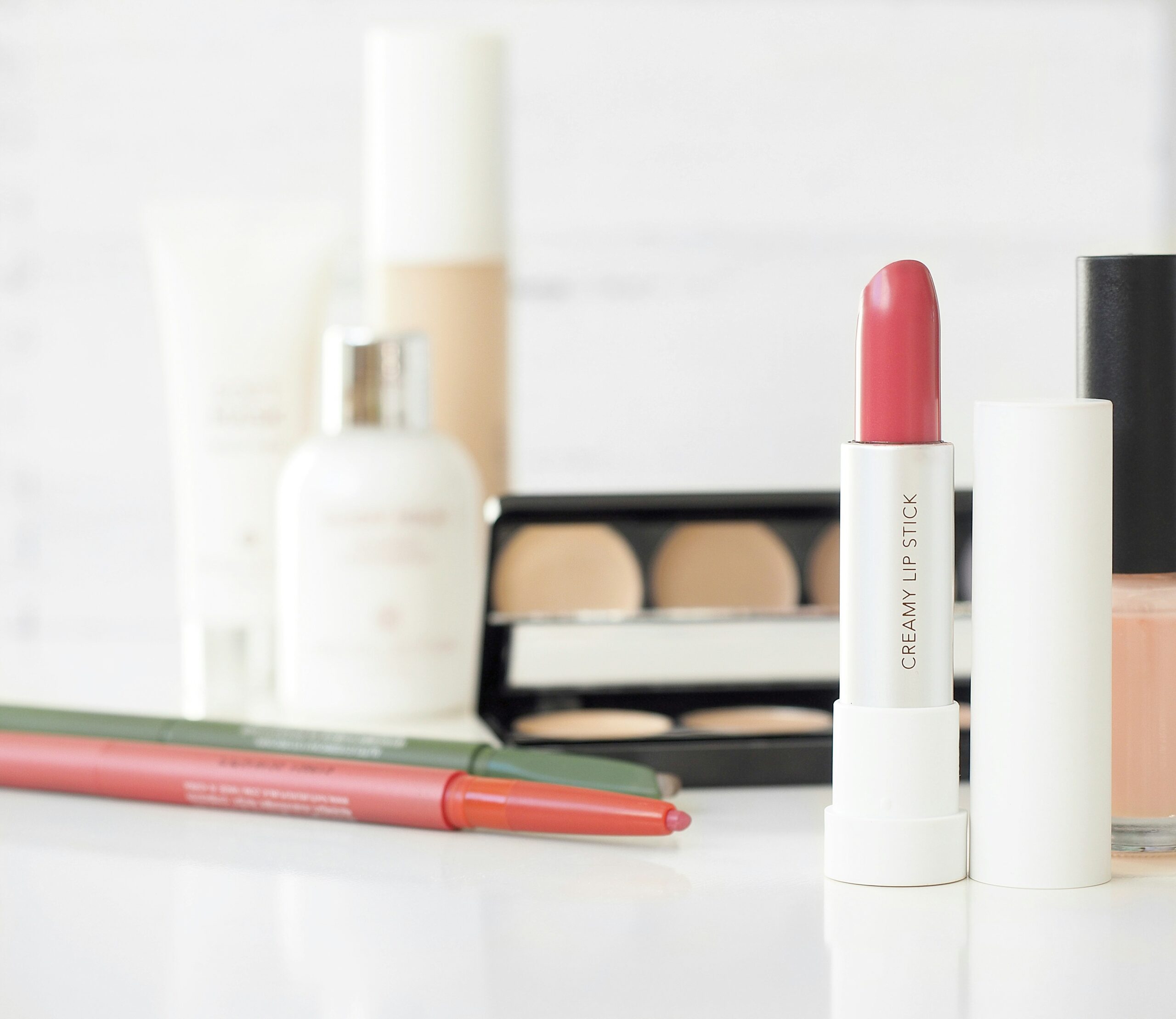 Clean makeup brushes lined up neatly against a white background.