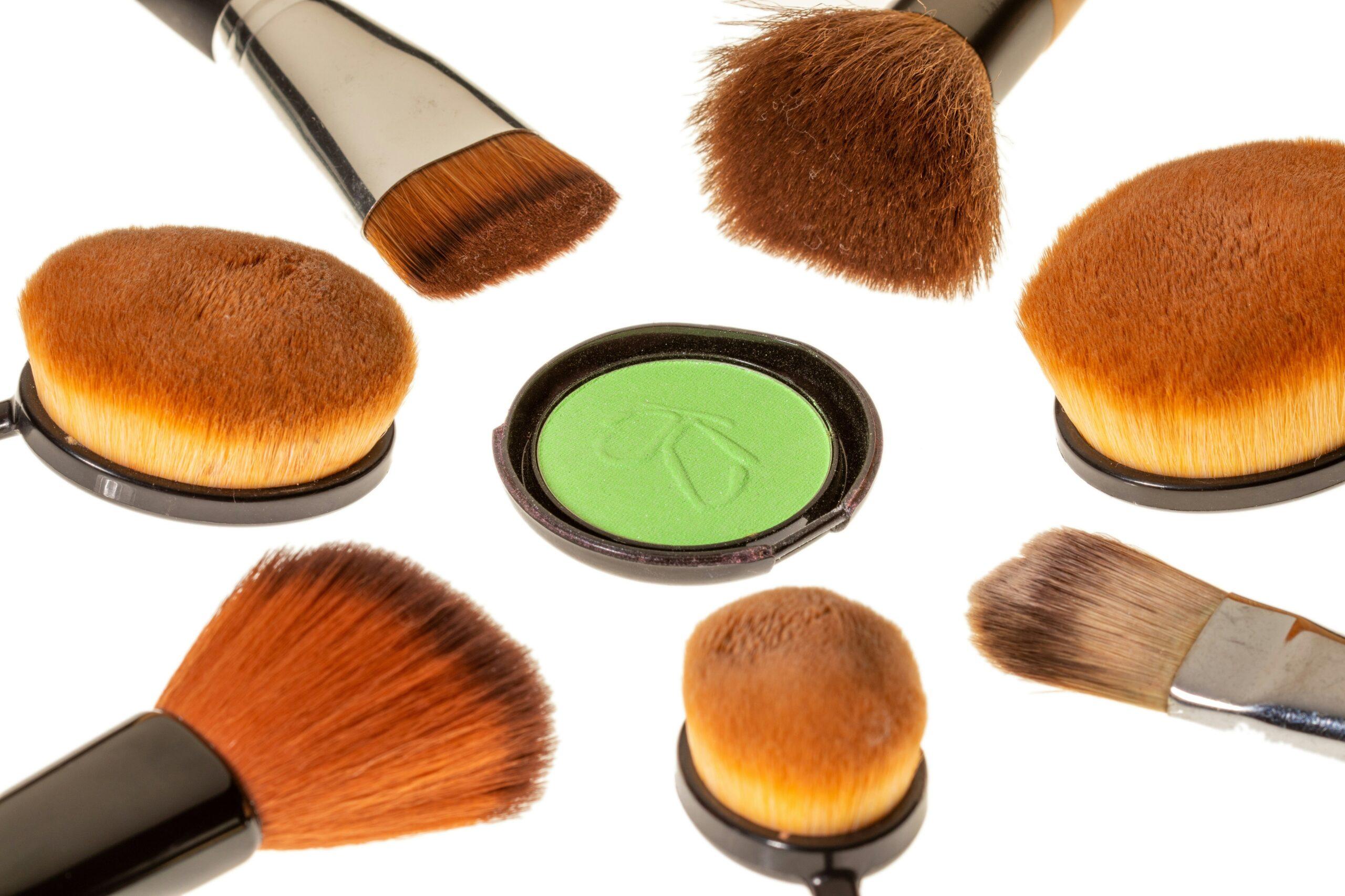 A woman looking frustrated while holding a makeup brush