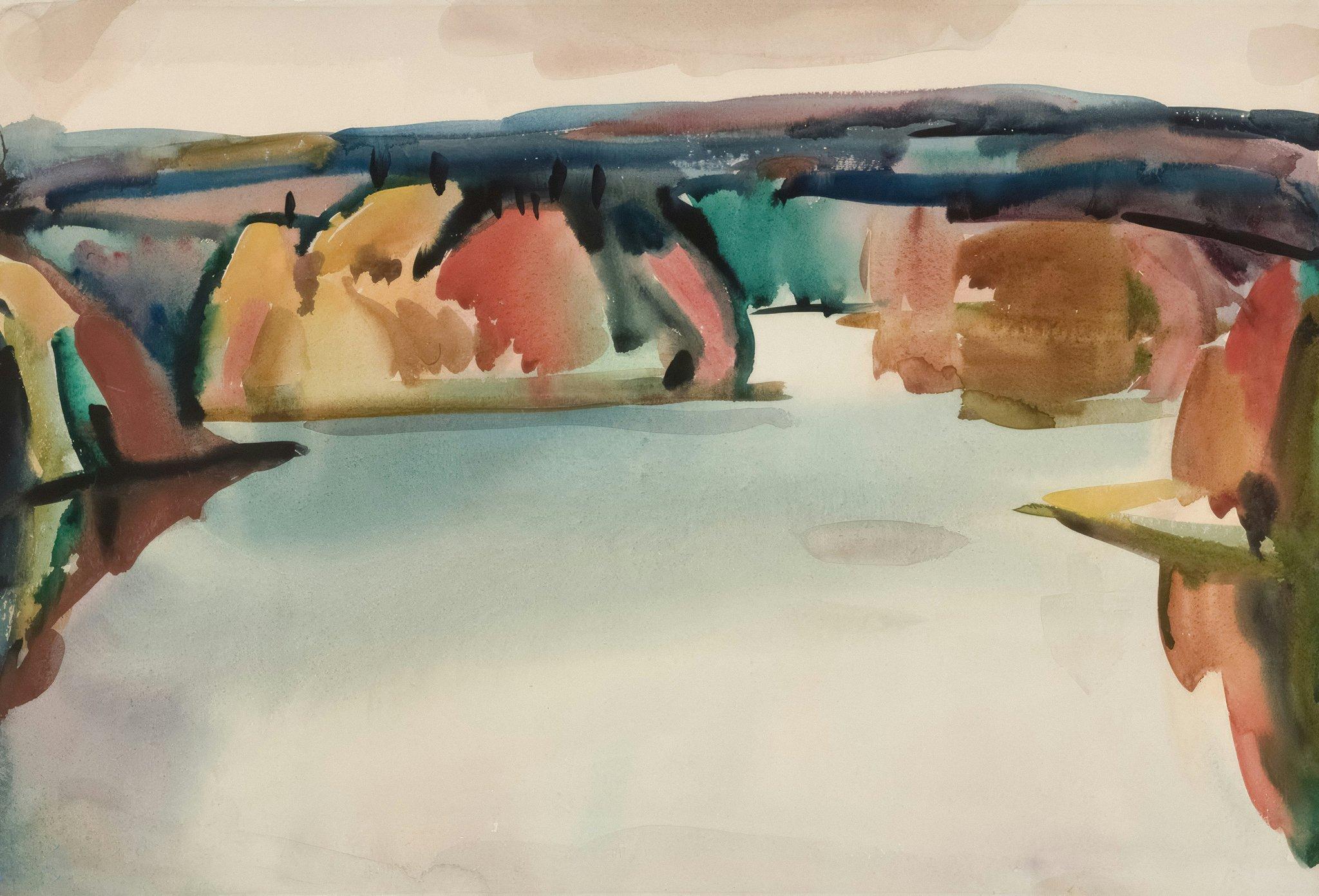 A hand holding two different types of makeup brushes side-by-side for comparison