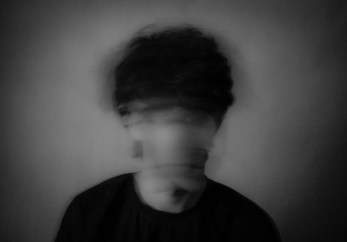 An editorial makeup artist working backstage at a fashion show.