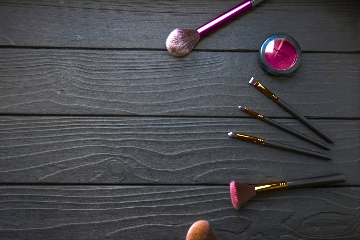 Brushes, magnifying mirror, and primer laid out neatly.