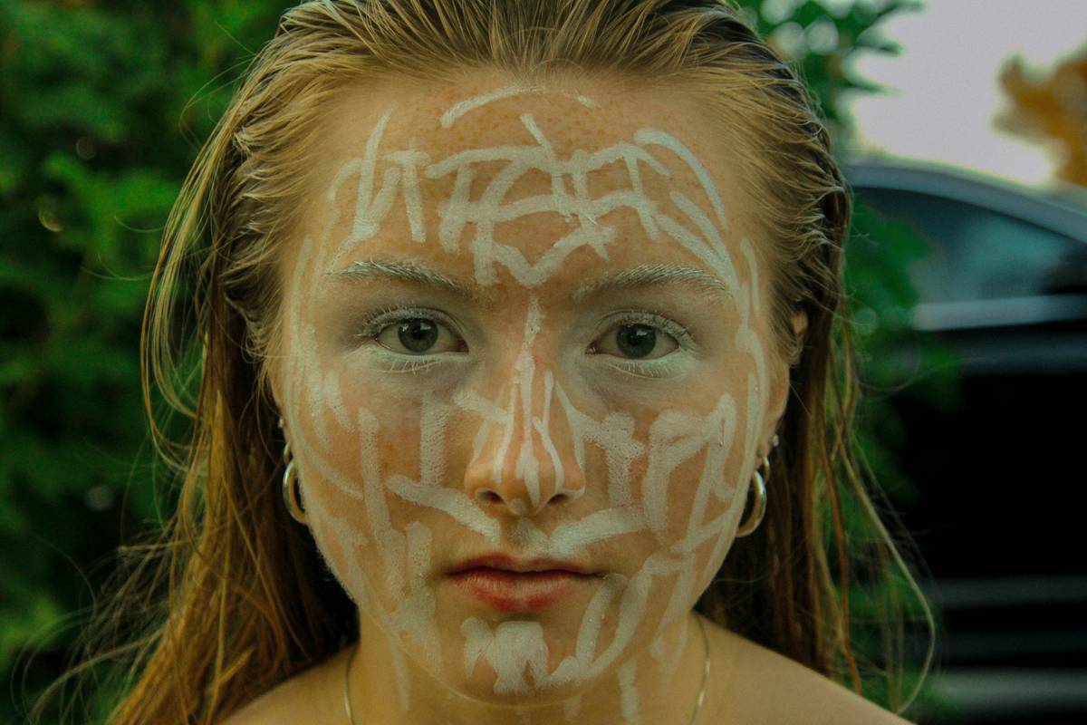 Pat McGrath backstage applying bold gold eye makeup during fashion week.