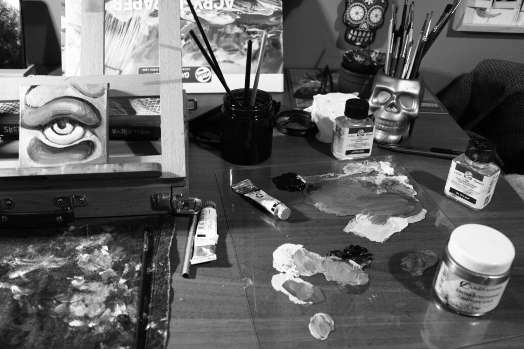 black and white photograph of art supplies on a table