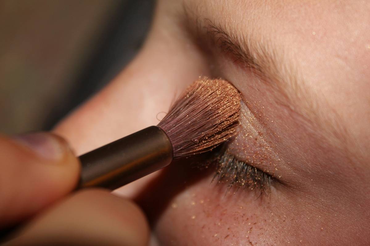 Close-up shot demonstrating proper blending technique using a beauty blender.