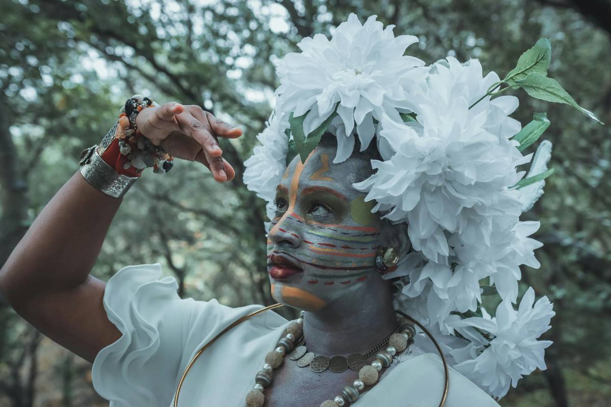 A vibrant fantasy makeup palette featuring shimmering blues, greens, and purples.